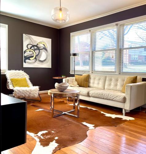 a living room with a couch and a table at Cameron Village Modern Stylish Condo in Raleigh