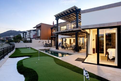 a house with a golf course in front of it at Luxe 5 BDRM Copala Villa GOLF Minutes to Marina in Cabo San Lucas