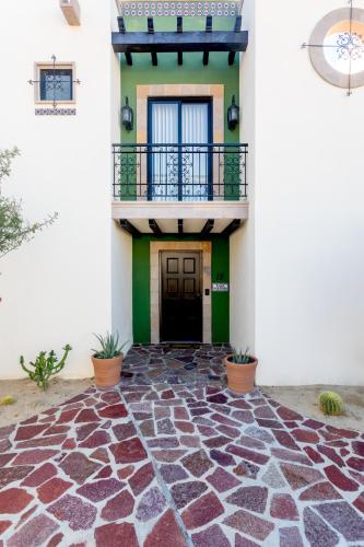 a house with a stone floor and a balcony at Luxe 5 BDRM Copala Villa GOLF Minutes to Marina in Cabo San Lucas