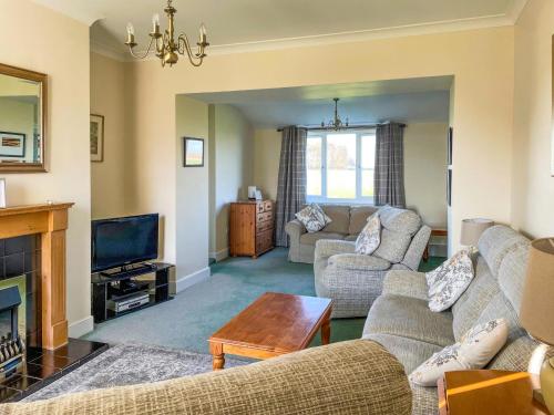 a living room with two couches and a tv at Thelma's House - Uk48886 in Belford
