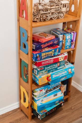 a stack of books on a book shelf at Cozy Weekend Retreat in W Knoxville in Knoxville