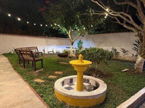 a yellow fire hydrant in the middle of a yard at Casa Quinta Vereda San Nicolas La Mesa in La Mesa