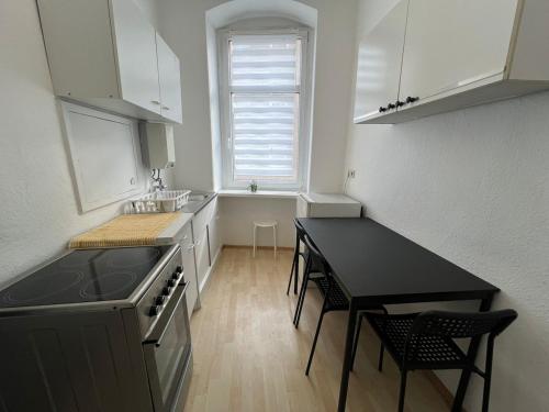a kitchen with a sink and a table in it at Berlin flat W 3 separate rooms N0 in Zeitz