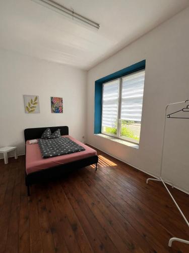 a room with a bed in a room with a window at Berlin flat W 3 separate rooms N0 in Zeitz