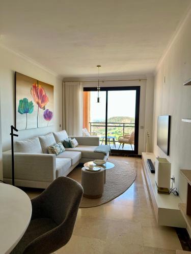a living room with a couch and a table at M&M La Cala Suite in La Cala de Mijas