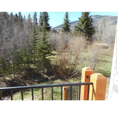 a balcony with a fence and some trees at River Retreat in Cuchara Valley in La Veta