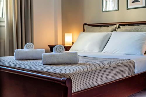 a bedroom with a bed with two towels on it at Dioni Apartments in Plataria