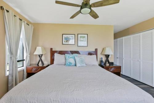 a bedroom with a bed with a ceiling fan at Condos in Kapaa in Kapaa