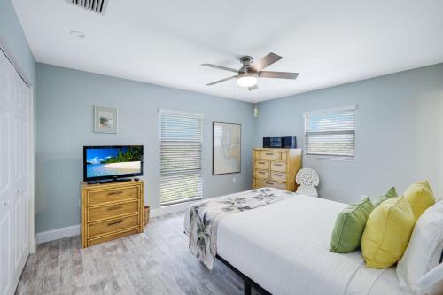 a bedroom with a bed and a flat screen tv at Seashells #45 in Ybel