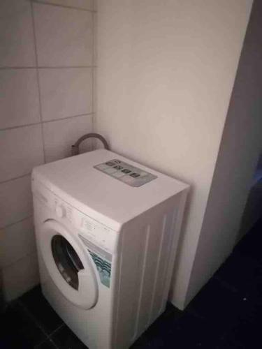 a washing machine in a corner of a room at Nice apartment with balcony & garden N1L in Zeitz