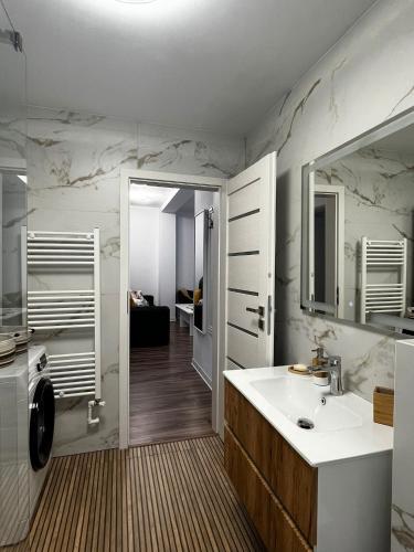 a bathroom with a sink and a mirror at Apartament central Blaj in Blaj