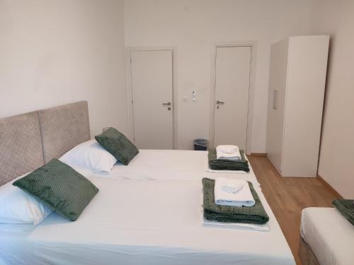 two beds in a room with towels on them at Beach Villa Selce in Selce