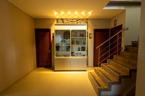 a hallway with a refrigerator and stairs in a house at Hotel Santa Clara Boutique in Montería