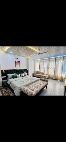 a bedroom with two beds and a couch in it at Velvet Hills Barog in Barog