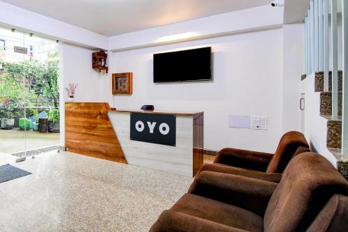 a living room with a tv on a wall at Hotel O Vaisravana in Gangtok