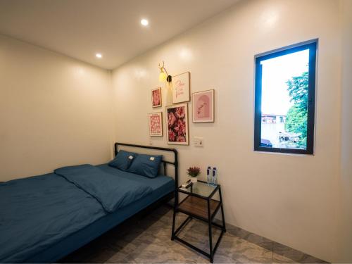 a bedroom with a bed and a window at Strawberry House , Tour & Motorbikes Rentel in Ha Giang