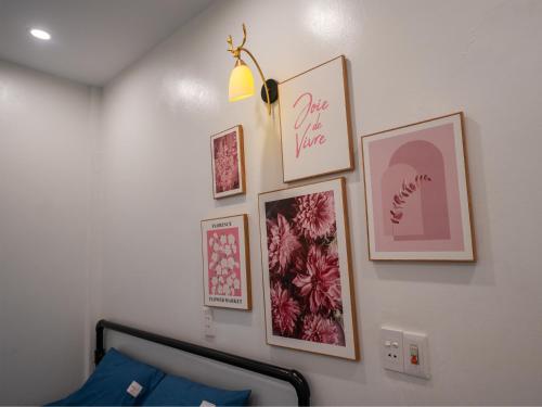 a bedroom with framed pictures on a wall at Strawberry House , Tour & Motorbikes Rentel in Ha Giang