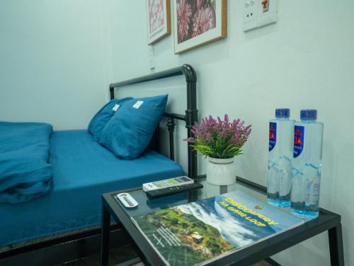a living room with a blue couch and a table at Strawberry House , Tour & Motorbikes Rentel in Ha Giang