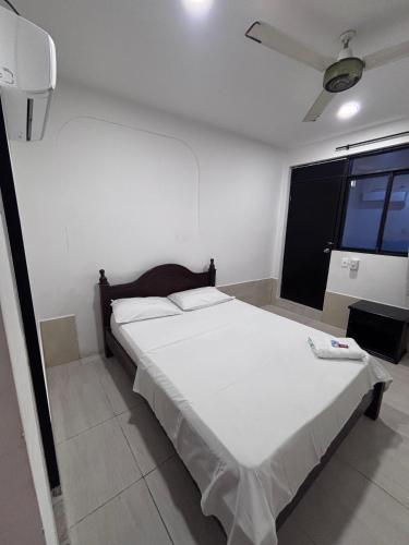 Postel nebo postele na pokoji v ubytování Hotel Colonial City