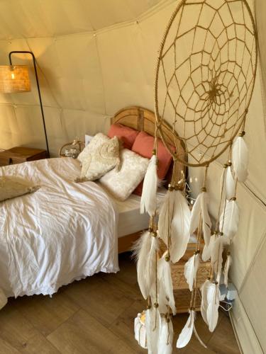 a bedroom with a bed with a fan at Maya Lena dome in Belleghem