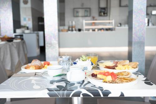 a table with three plates of food on it at Hotel Graziella in Martinsicuro