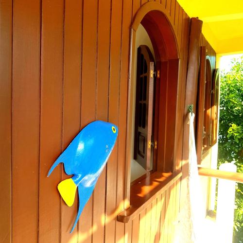 a blue fish painted on the side of a house at Morro Beach Hotel in Morro de São Paulo