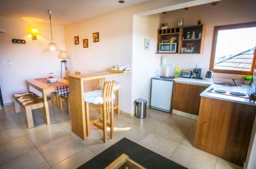 a kitchen and dining room with a table and a kitchen and a table and chairs at Blue Aparts Dina Huapi Bariloche in Dina Huapi