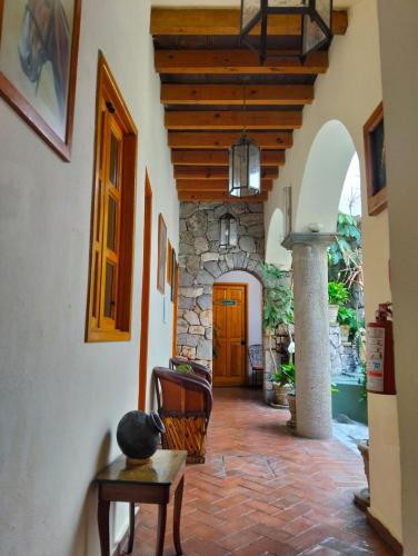 a hallway of a house with a stone wall at Hotel Antigua Casa de Piedra in San Miguel de Allende