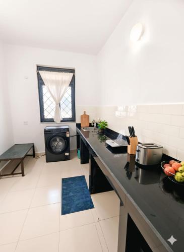a kitchen with a counter top and a stove at Shraddha hospitality in Calangute