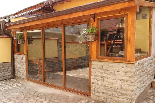 a building with large glass windows on it at Guest house Dinaya-2 in Dobrinishte