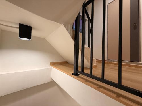 a staircase in a house with glass windows at Serenova Hotel Siam Paragon, Bangkok in Bangkok