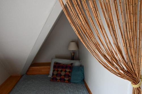 a attic room with a bed and a curtain at Lovely Town Apartment - Sleeps 5 Parking & Garden in Gram