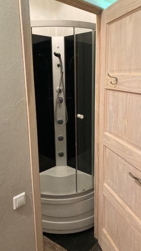 a shower with a glass door in a bathroom at Āgenskalns 2 in Riga