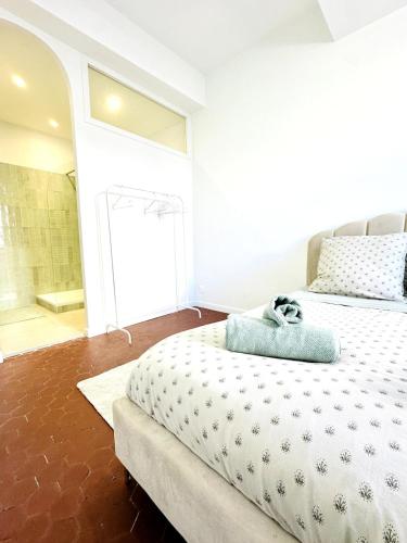 a bedroom with a large bed and a bathroom at Design and Provençal Elegance Suite in Aix in Aix-en-Provence