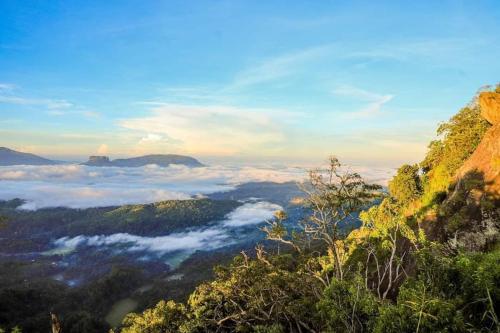 a view of a valley of clouds in the mountains at Villa de sunrise garden 