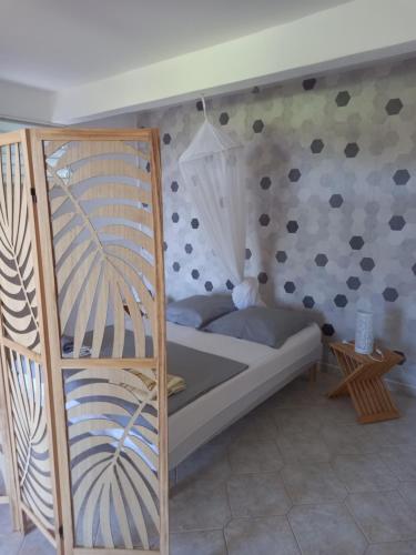 a bedroom with a bunk bed with a wall at Gîte des voyageurs in Vieux-Habitants