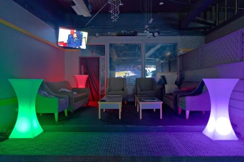 a waiting room with chairs and a table and lights at Midtown Inn in Saskatoon