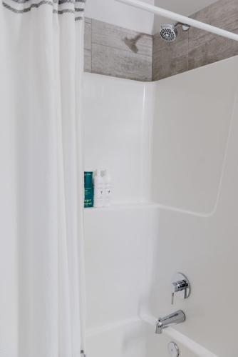 a shower with a white shower curtain in a bathroom at NordicSauna 3 Ensuite baths TheYellowDoorRetreat in Edmonton