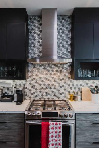 a kitchen with a stove with a red and white towel at NordicSauna 3 Ensuite baths TheYellowDoorRetreat in Edmonton