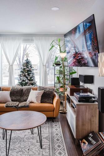 a living room with a couch and a christmas tree at NordicSauna 3 Ensuite baths TheYellowDoorRetreat in Edmonton