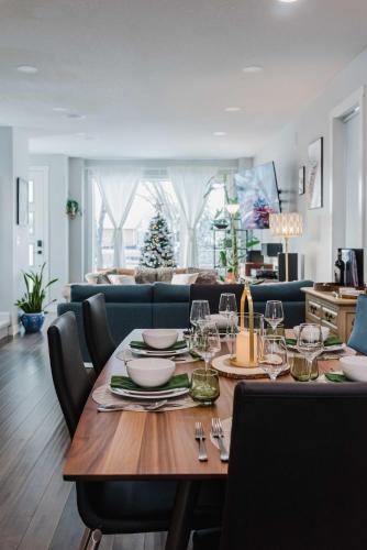 a dining room with a table with plates and wine glasses at NordicSauna 3 Ensuite baths TheYellowDoorRetreat in Edmonton