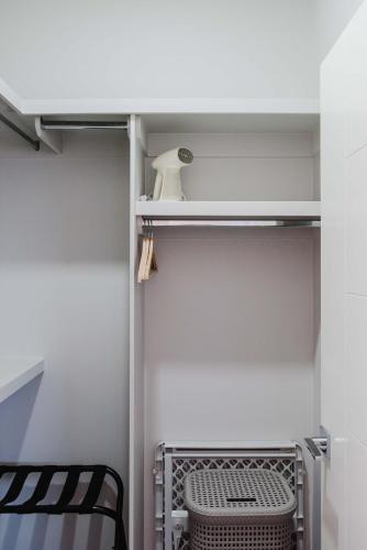 a closet with a shelf and a chair in a room at NordicSauna 3 Ensuite baths TheYellowDoorRetreat in Edmonton