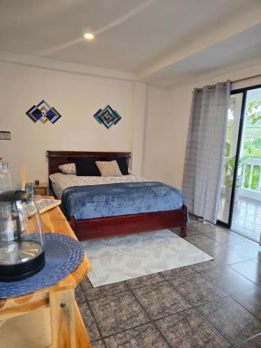 a bedroom with a bed and a table at Palmendros Hosteria in Montañita
