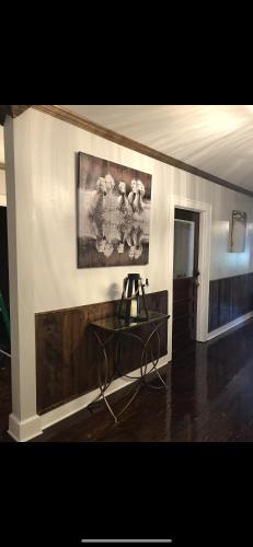 a room with a painting on the wall and a table at Boone Trace Inn Room 2 in Pineville