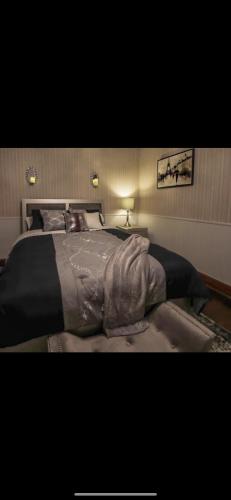 a bedroom with a large bed with a black blanket at Boone Trace Inn Room 2 in Pineville