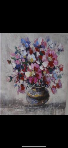 a painting of a vase with flowers in it at Boone Trace Inn Room 2 in Pineville