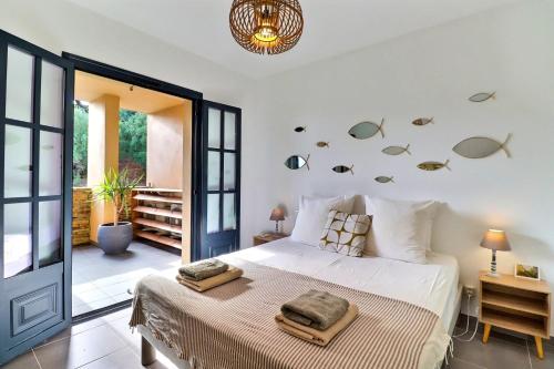 a bedroom with a bed with fish on the wall at Rocca Bella Escape by the Sea and Vineyards in Patrimonio