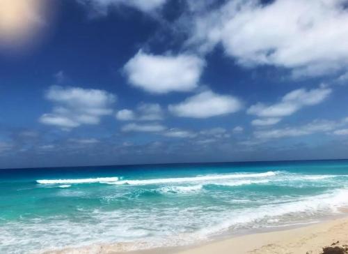 a view of the ocean with a blue sky and clouds at Coastal Escape - Ballah Resort in El Hamam