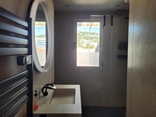 a bathroom with a sink and a window at Rooftop apartment Cannes center - Parking in Cannes