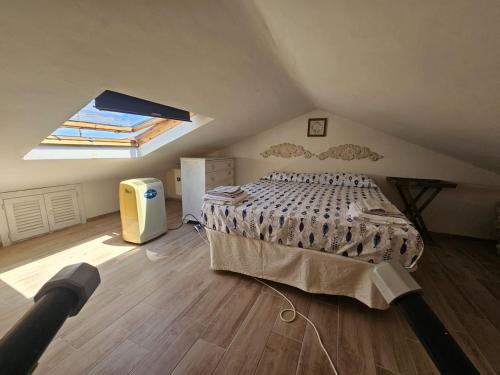 a bedroom with a large bed in a attic at La Maga Circe in San Felice Circeo